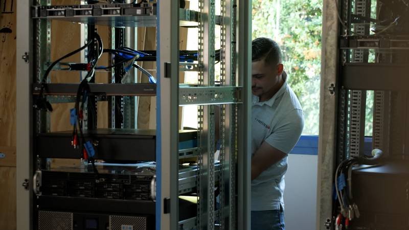 Themys technician that installs a cabinet for a vessel's communication system